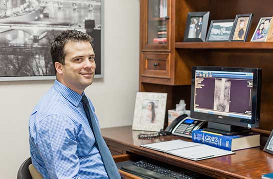 Chiropractor Escondido CA Dr. Scott Karges At Desk