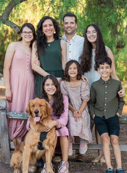 Scott Karges Poses Outside with his Family and His Dog